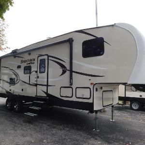 Air conditioned RV trailer in quiet caravan site