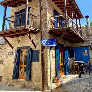 Ta Lofitika traditional stone house with balcony.