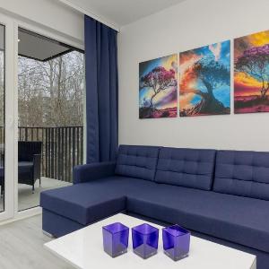 Dark Blue and Grey Apartment with Pastel Bedroom in Warsaw by Noclegi Renters