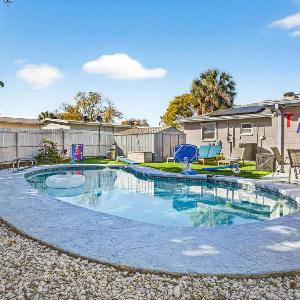 Family Putting Green Oasis BBQ Cornhole Heated Pool