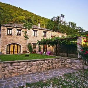 Traditional stone house in green Zagori village.